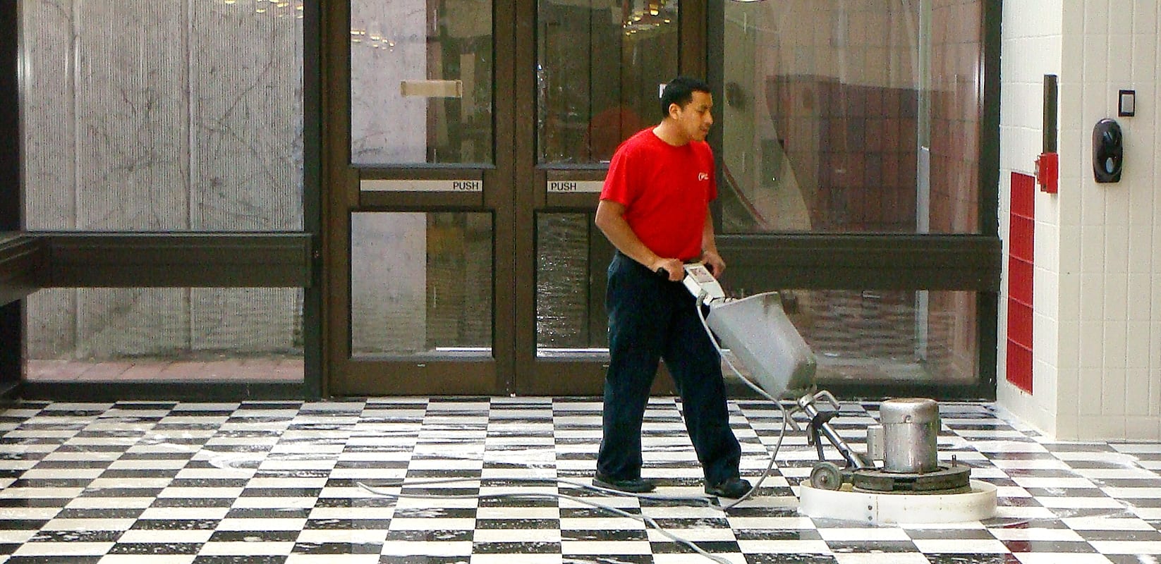 Man polishing hard floors, providing commercial floor cleaning services.