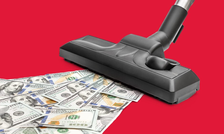 Vacuum cleaning up dollar bills on floor